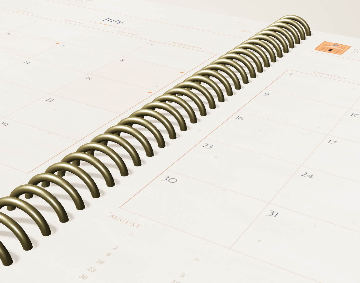 Close-up of the gold coil spiral binding threading the calendar pages — a real, lay-flat, writable planner